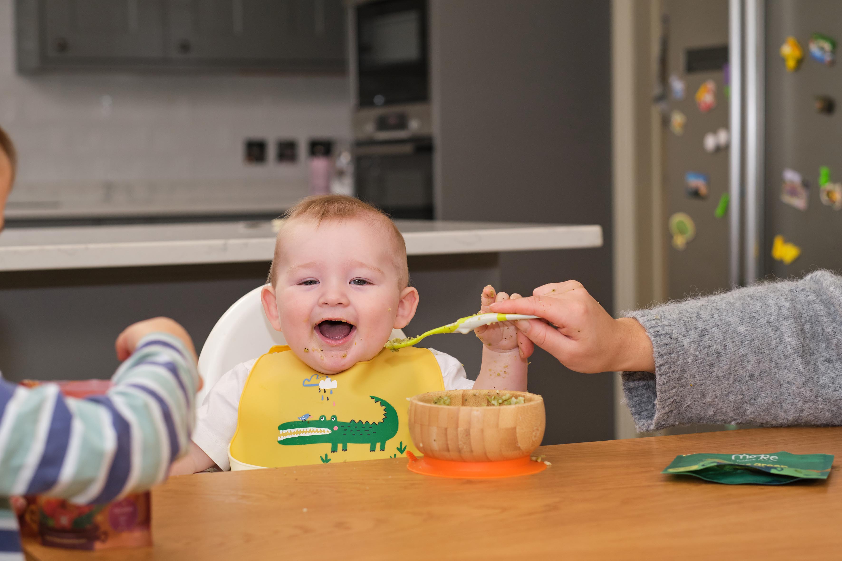 a baby in a high chair eating more toddler meal for lunch