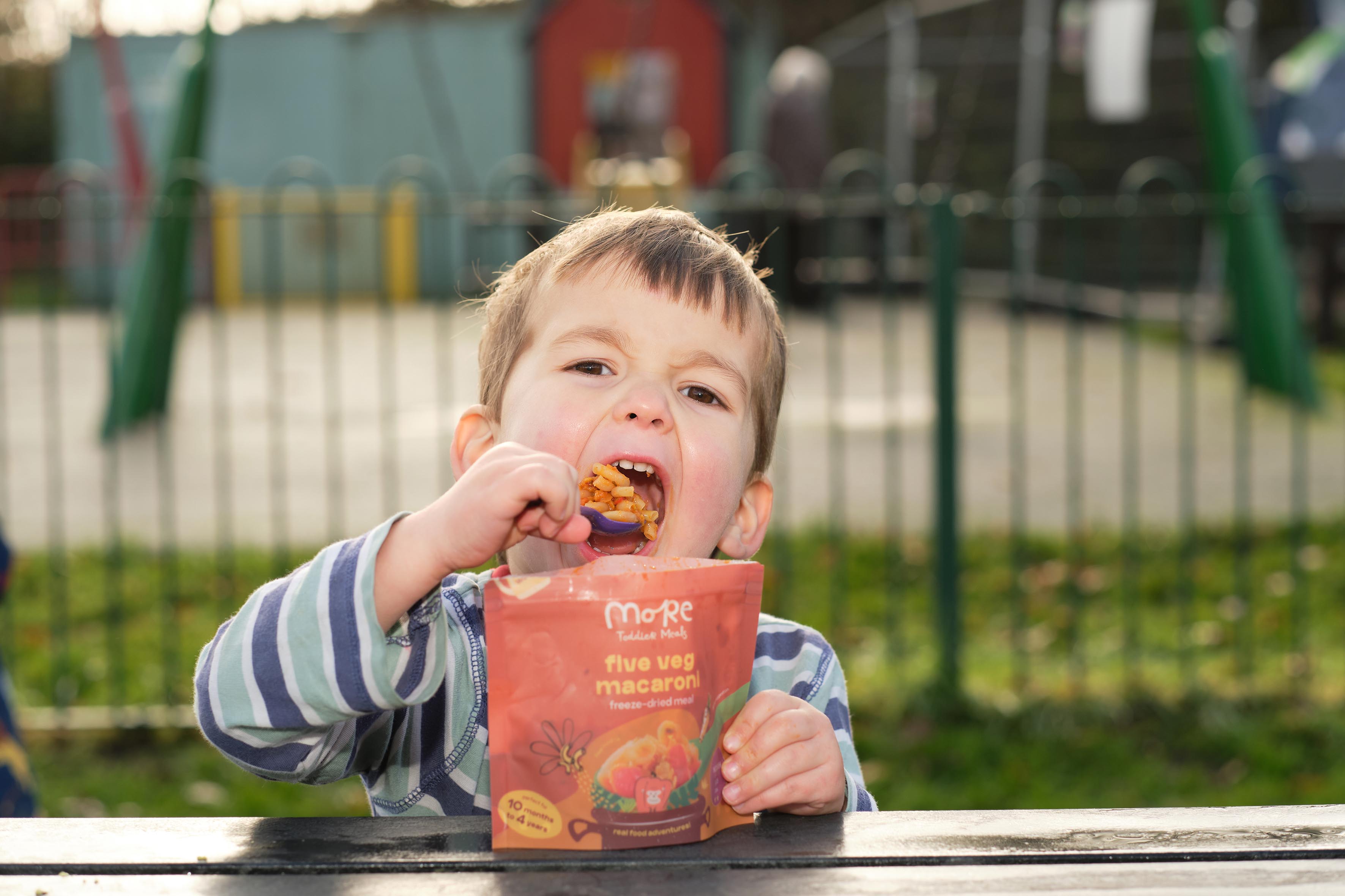 toddler eating from a more toddler meal at a playground. easy and healthy meals. 